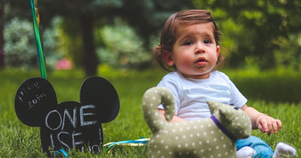 One year old baby playing with age-appropriate developmental toys